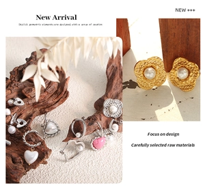 Detailed view of vintage gold heart and floral earrings with pearls and natural pink stones