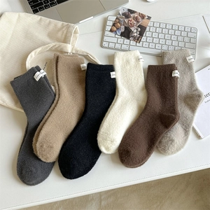 Flat lay of six thick velvet thermal socks in solid colors with Honeybear fabric labels