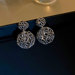 Retro silver hollow geometric double-ball stud earrings with intricate floral cutouts