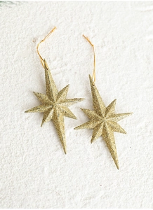 Detail view of two gold glittery eight-pointed star ornaments with matching gold strings