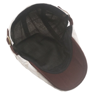 Detail of plaid newsboy cap showing cotton lining and adjustable brass metal side buckle