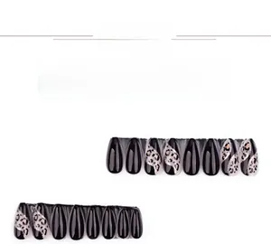 Detail of almond-shaped fake nails with leopard print, black finish, and silver glitter lines