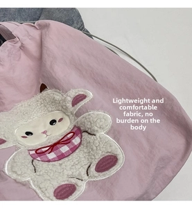 Detail of pink canvas tote with fluffy sheep embroidery and soft textured fabric