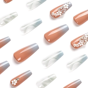 Long trapezoid gradient press-on nails with butterfly, flower, and rhinestone accents