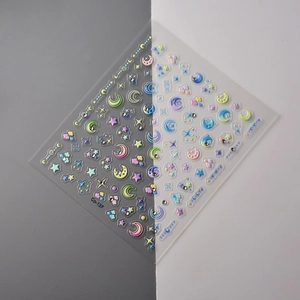 Macro detail of Co-137 nail stickers with macaron 3D stars, moons and mini rhinestones