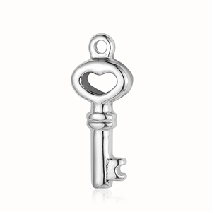 Macro view of polished silver heart key pendant in stainless steel for DIY jewelry making