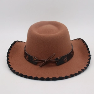 Close-up of brown wool felt cowboy hat with black wave stitching and leather decorative band