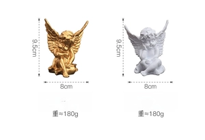 Detail of small white and gold cupid angel statues showing 9.5cm height and resin texture