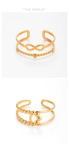 Detail of gold-plated infinity and bead charms on adjustable double-layer ring