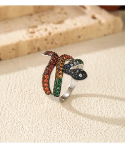 Macro detail of snake ring featuring gradient colored cubic zirconia on silver band