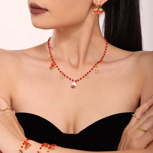 Christmas themed jewelry set with red garnet beads and gold Christmas charm pendants