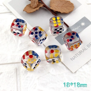 Detailed view of six 18mm transparent acrylic dice with colored dots for DIY jewelry
