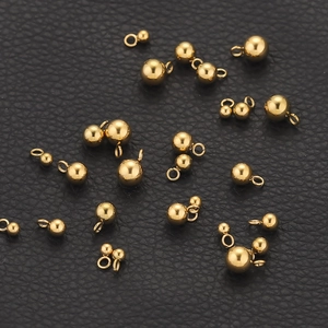 Polished gold round sphere charms with loop rings for DIY jewelry on black leather
