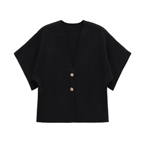 Close-up of black V-neck knitted cardigan featuring elegant golden metal buttons