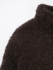 Macro view showing the soft texture and warm fiber of dark brown sherpa fleece fabric