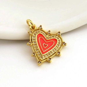 Golden heart pendant with red enamel and white zircon inlay on white background