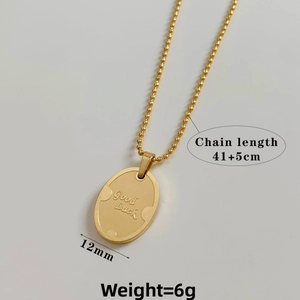 Detail of gold oval Good Luck pendant necklace with 41+5cm chain and 12mm width charm