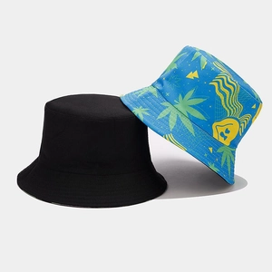 Detail of a black cotton bucket hat next to a blue hat with green leaf and art prints