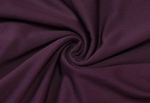 Detail of dark purple knit fabric showing soft texture and elegant ruffled drapes