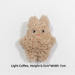 Detailed view of light coffee plush rabbit brooch made of soft curly lamb fleece fabric