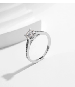 Macro shot of 1 carat moissanite ring with four-prong setting and side accent stones