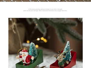 Miniature red and green Christmas sleigh figurines with Santa and reindeer on snow