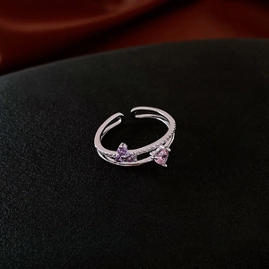 Macro shot of silver open ring with double-layer band and heart-shaped zircons