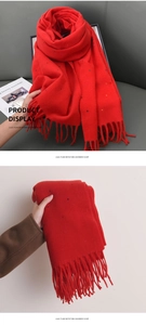 Detail view of red imitation cashmere scarf with colorful polka dots and fringe