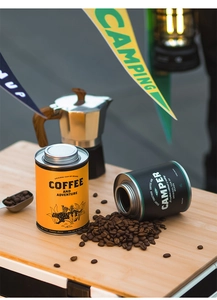 Detail of yellow and black tinplate coffee canisters with airtight screw lids for camping