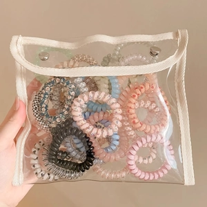 Elastici per capelli a spirale in vari colori e motivi in un sacchetto trasparente in PVC