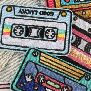 Retro cassette embroidery patches with Good Lucky text on denim fabric background