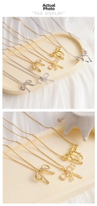 Detailed view of copper bow pendants with zircon crystals in gold and silver finishes