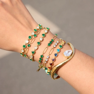 Set of gold titanium steel bracelets with colorful zircon stones worn on wrist