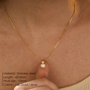 Minimalist stainless steel necklace with 10mm pearl pendant worn on model neck