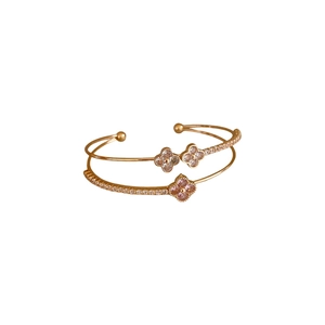 Double-layer rose gold clover bangle with zircon accents on a white background