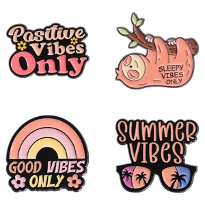 Pink sloth and rainbow enamel pins with positive quotes on white background