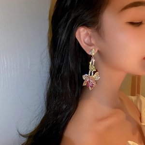 French vintage tulip earrings with colorful diamonds and gold finish on elegant model