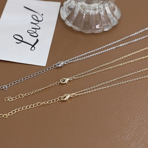 Detail of gold and silver adjustable chain necklaces with lobster clasps and extension links