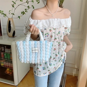 Detailed shot of bubble texture blue and white striped canvas tote bag with Love logo