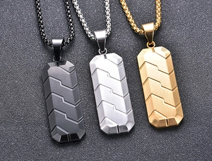 Close-up of hexagonal steel pendants with tire tread texture in black, silver, and gold