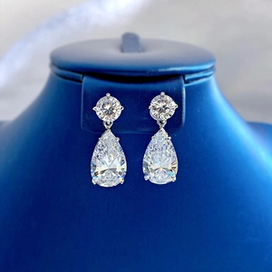 Macro shot of 925 sterling silver teardrop earrings with clear zircon stones on display