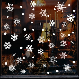 White Christmas snowflake and dot window stickers set on glass in festive home setting