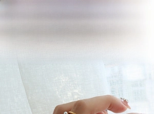 Detailed view of a gold geometric ring with pearl accent on a hand for model show