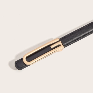 Women's minimalist black leather belt with elegant golden U-shaped buckle on white background