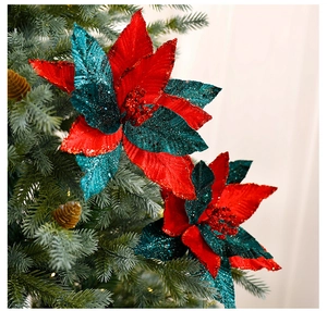 Detailed view of red and green velvet poinsettia flowers with glitter on Christmas tree