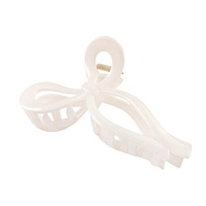 Detailed side view of large cream bow hair claw clip with golden metal spring