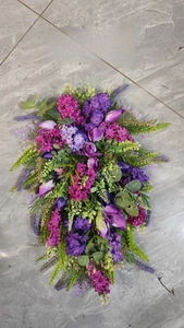 Detailed view of artificial purple tulip wreath with lush greenery for home wall decor