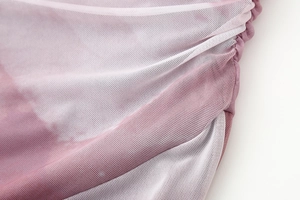 Close-up of pink and white gradient mesh fabric showing pleated details and texture