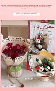 Close-up of Christmas bouquet with red roses and crochet snowmen in festive wrapping paper
