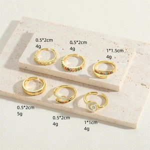 Set of vintage gold adjustable rings with crescent moon designs and rainbow stones